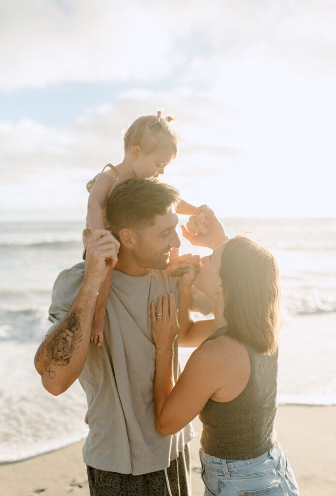 Candid family photo of the family on the beach in Oceanside
