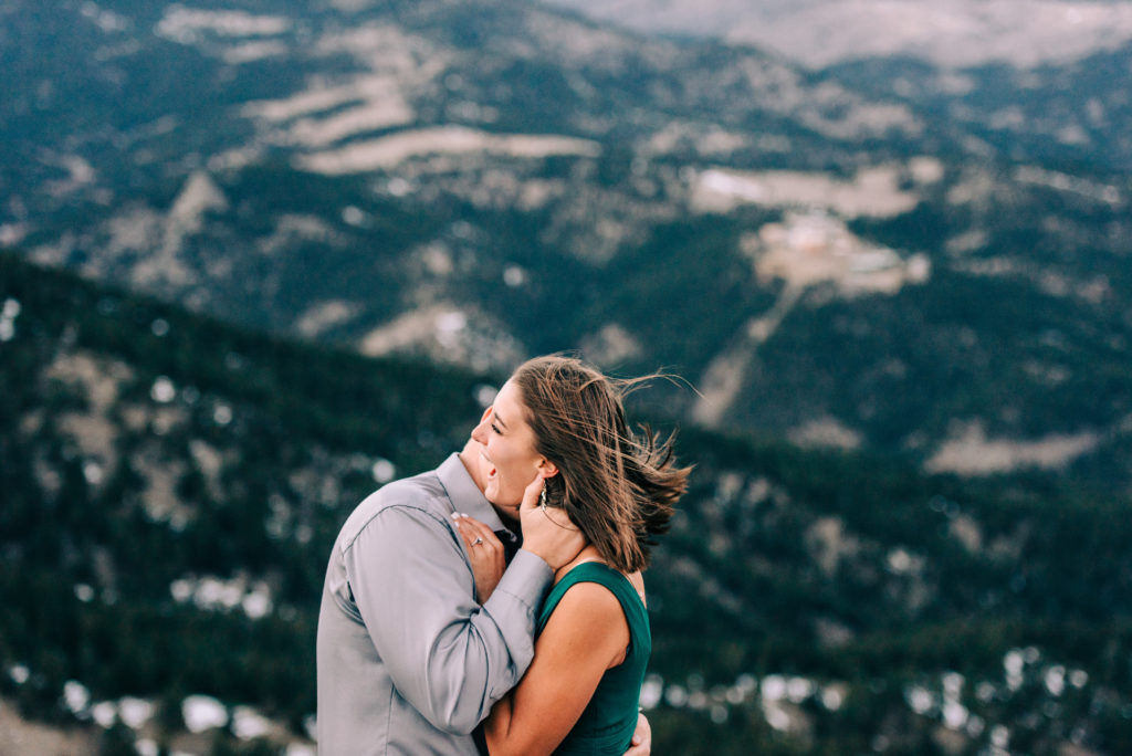 Engagement Couple Kissing in Boulder with a mountain backdrop