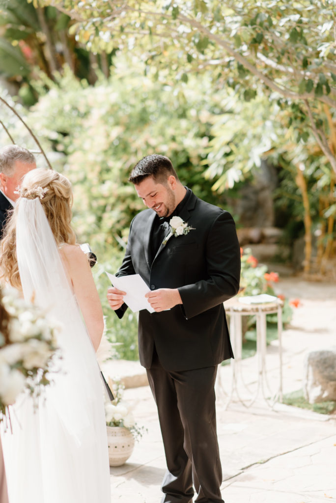 Bride and groom saying their vows to one another during their wedding ceremony at the Botanica Oceanside