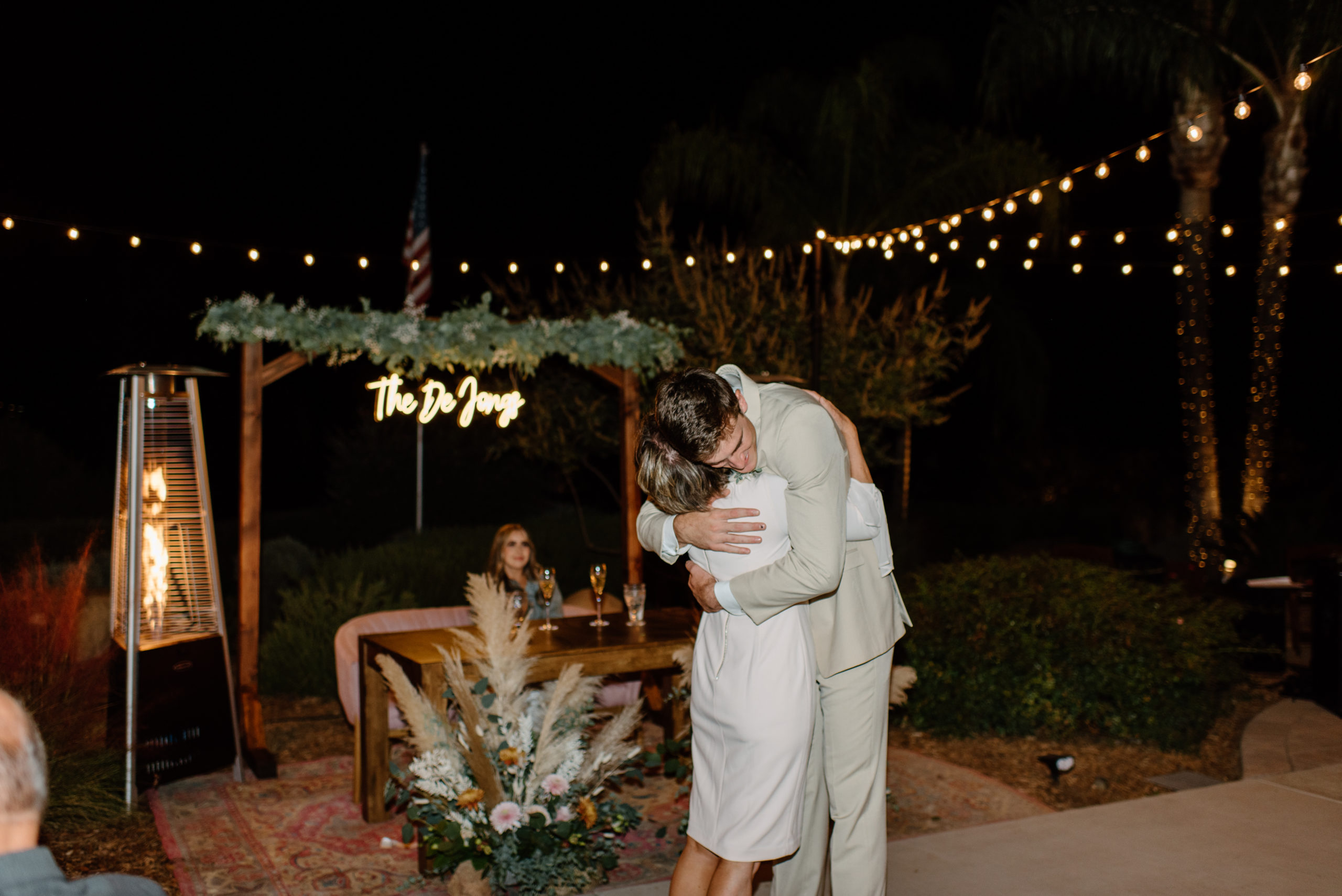 The groom and his mom sharing a hug during the wedding reception 