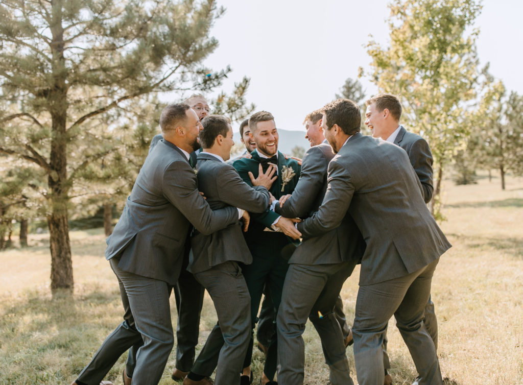 The groom and the groomsmen before the Spruce Mountain Ranch wedding ceremony 