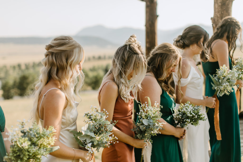 The bridesmaids lined up during the wedding ceremony at Spruce Mountain Ranch 