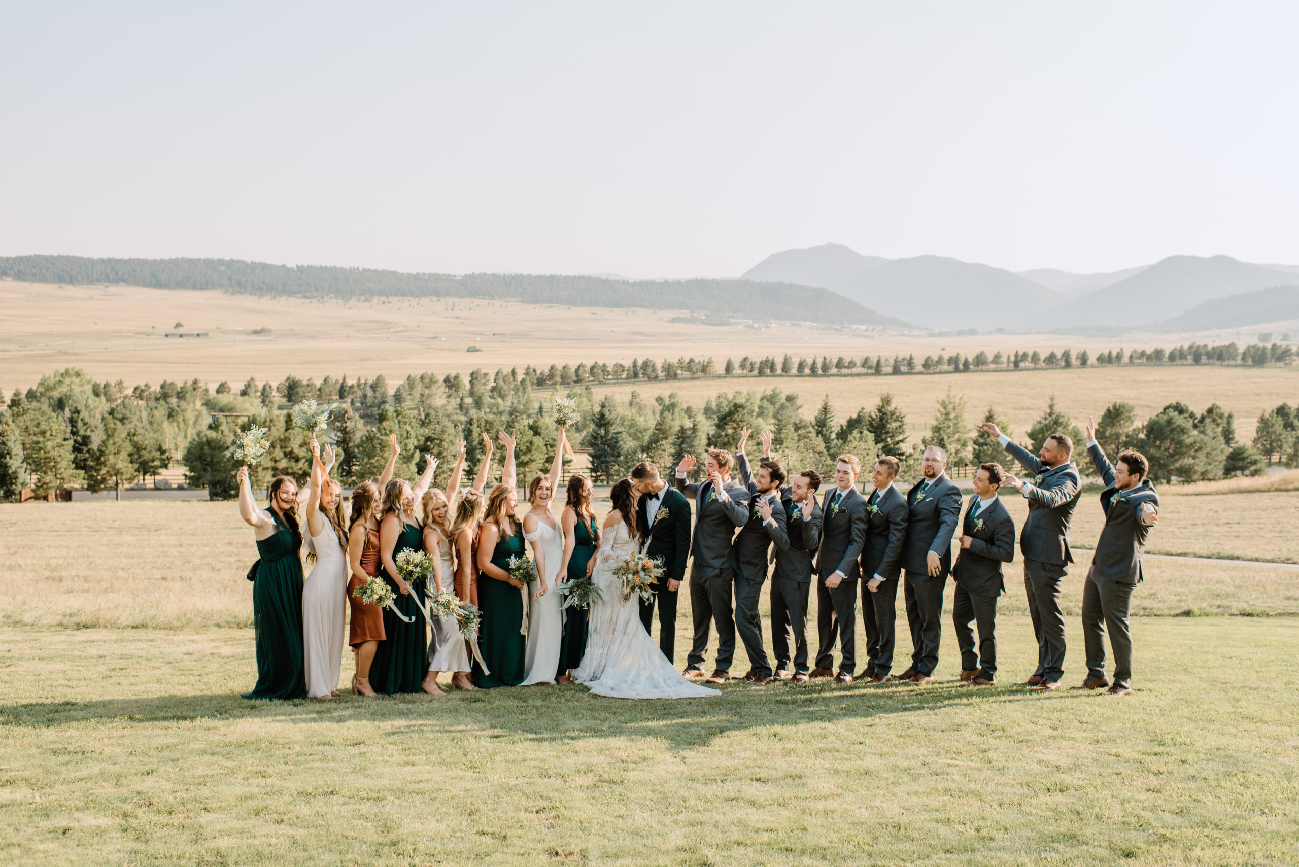 The bride and groom with the whole wedding party before the Spruce Mountain Ranch wedding ceremony 