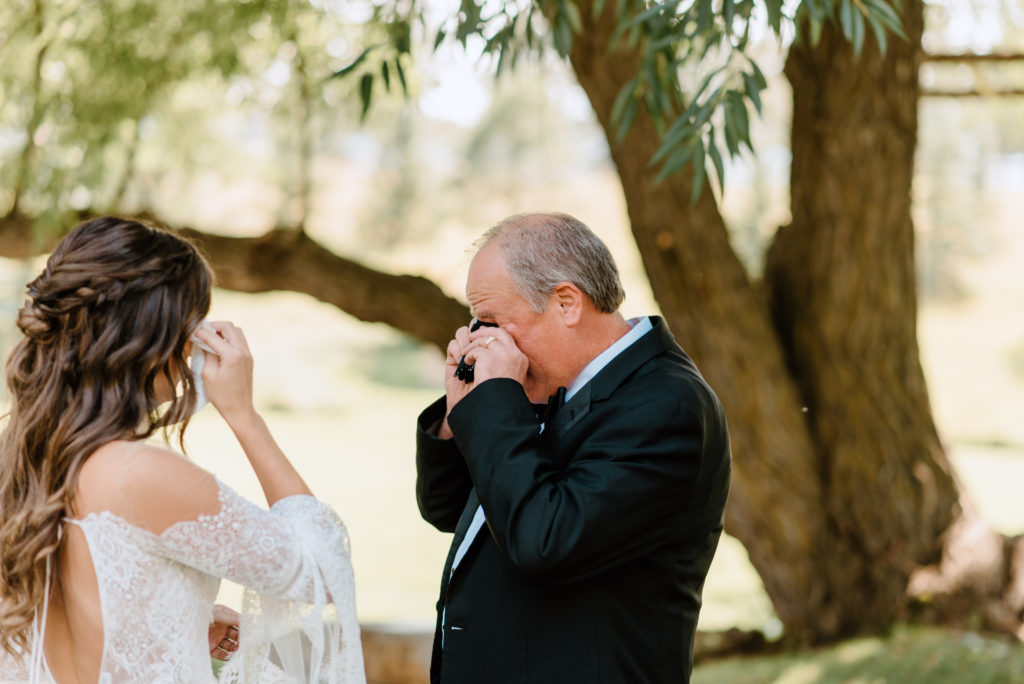 The bride and her dad crying together before the Spruce Mountain Ranch wedding ceremony 