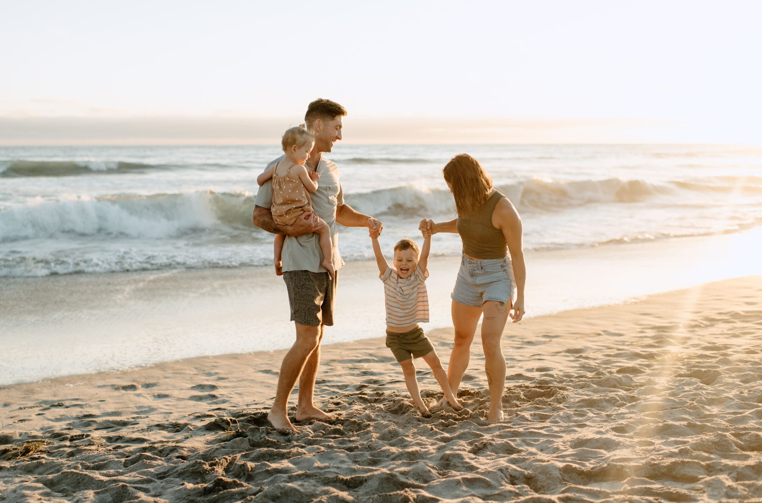 Oceanside family photographer captures laughter of the family on the beach