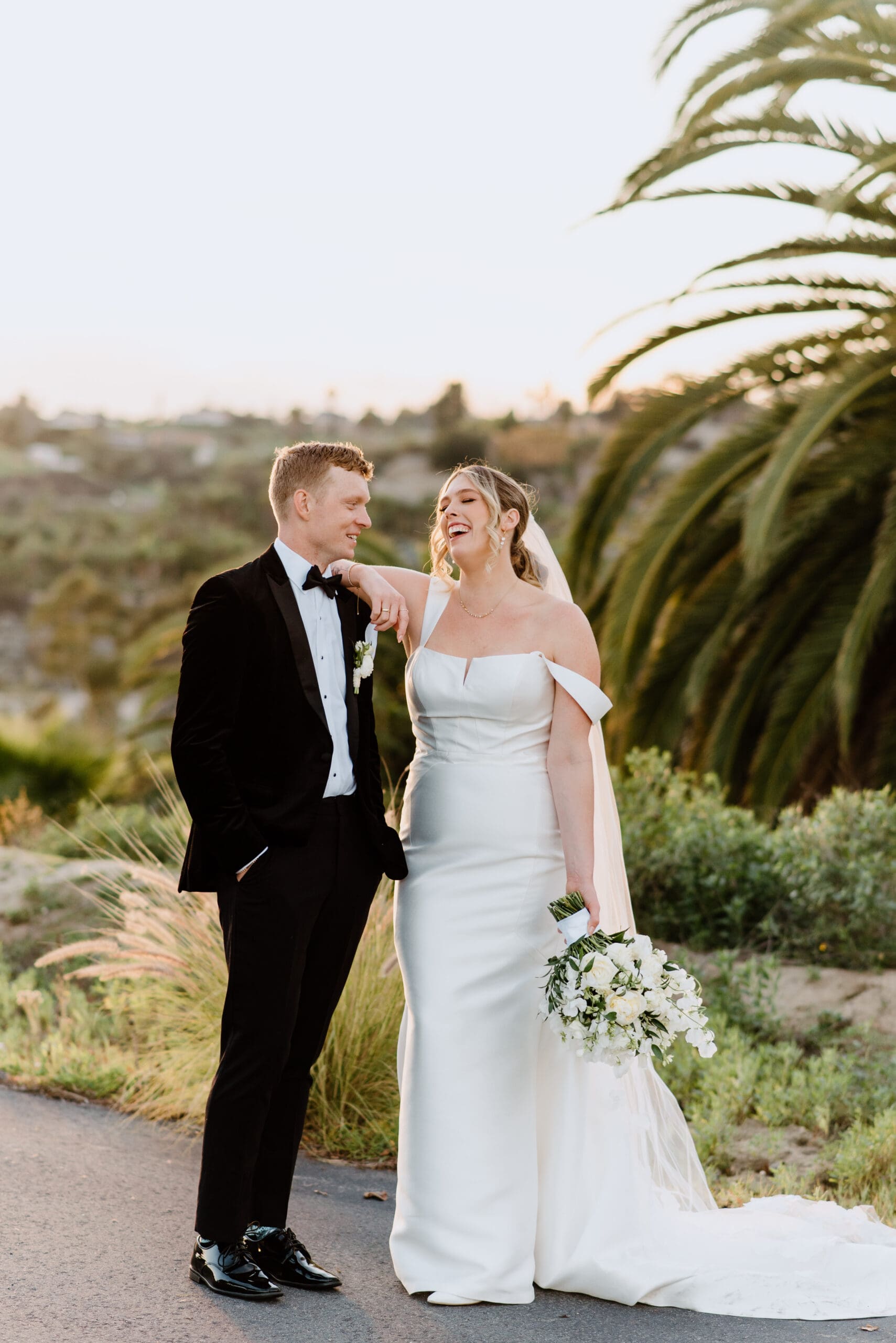 Bride and groom laughing for portraits on their wedding day at Tivoli