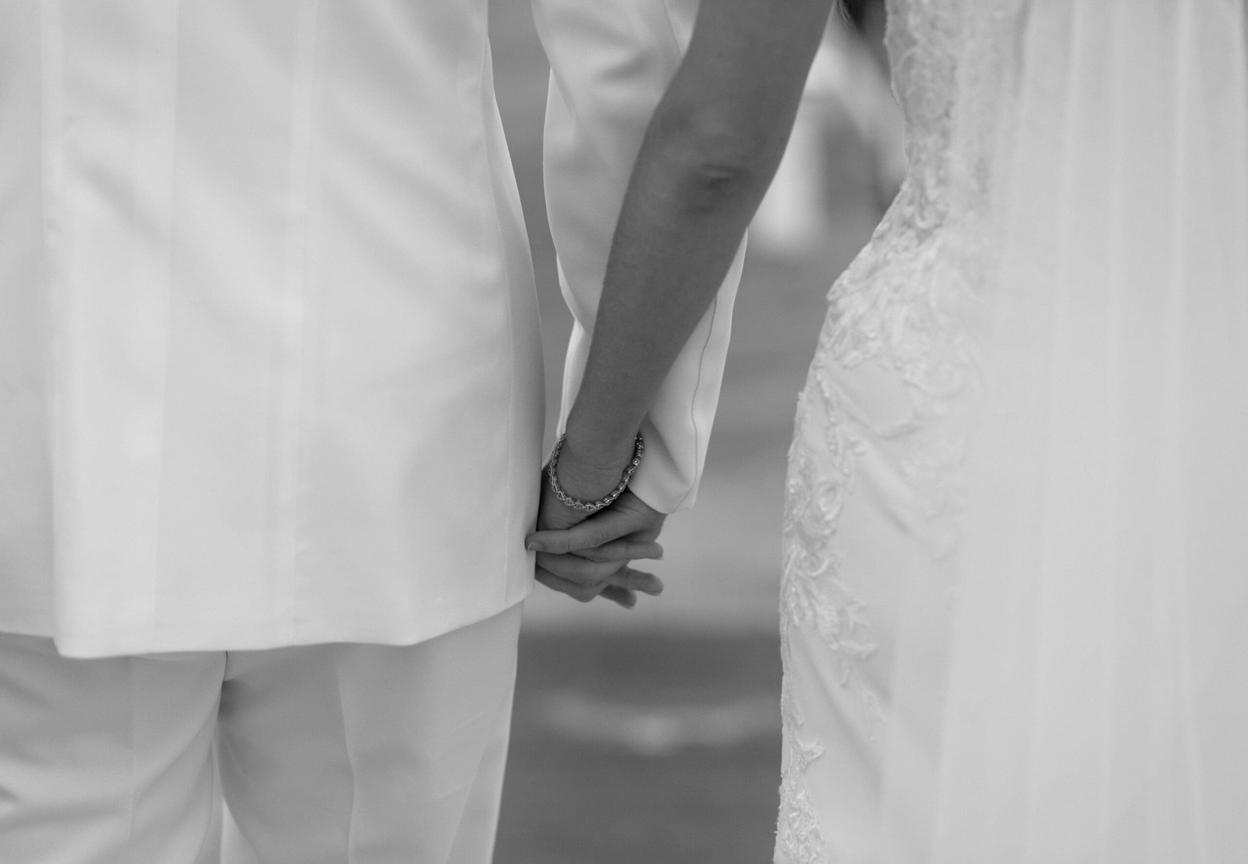 The bride and groom holding hands during portraits