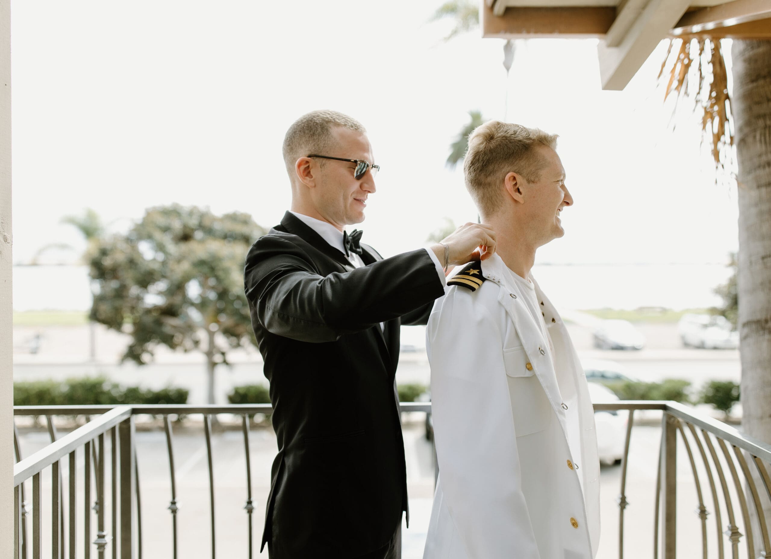 One of the groomsman helping the groom get ready