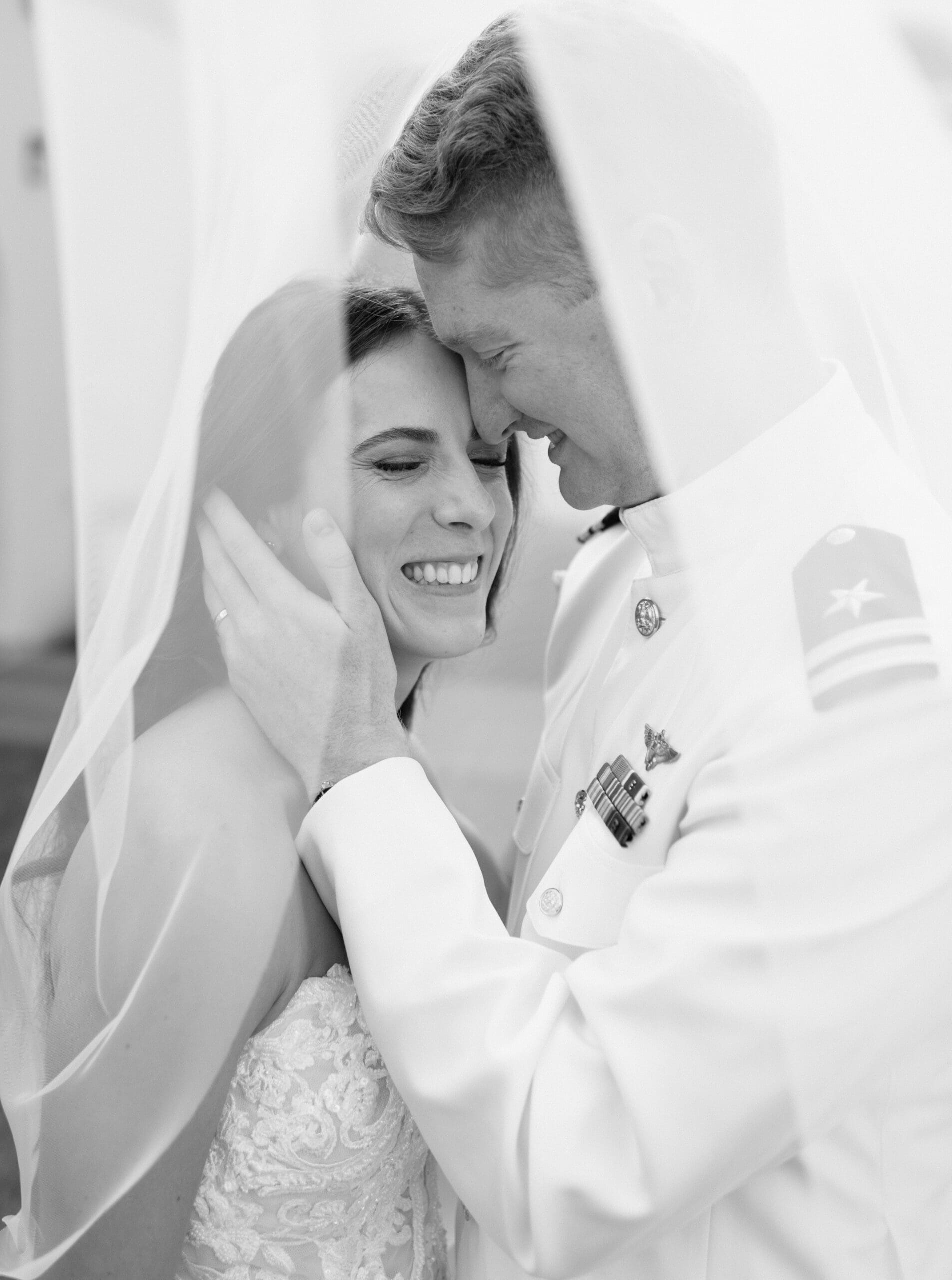 The groom embracing the bride under her veil for portraits for their Bali Hai Wedding