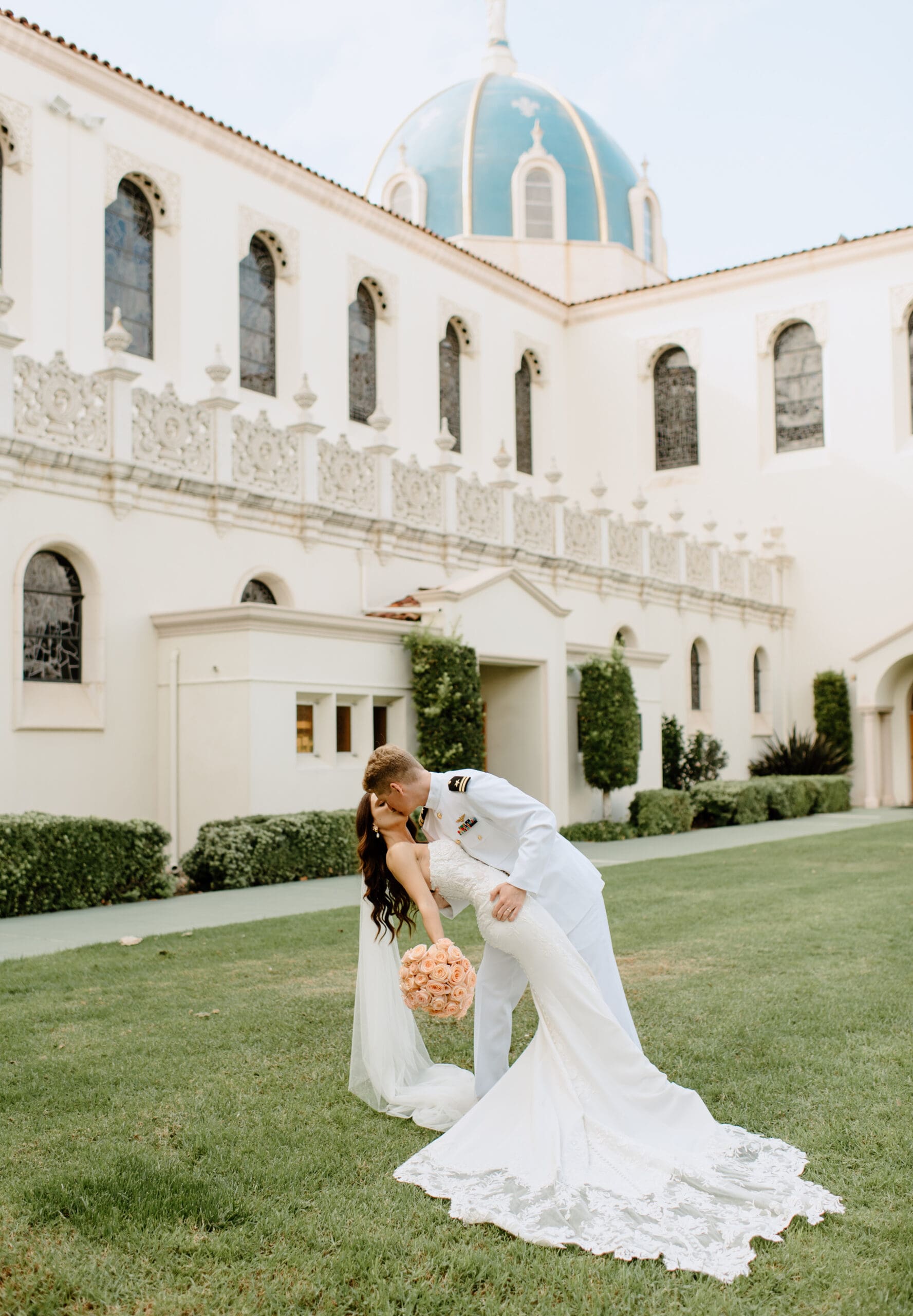 The bride and groom kissing during portraits
