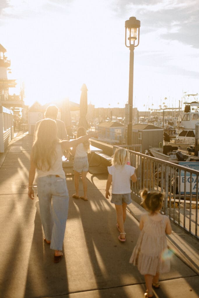 Family walking along the Oceanside Harbor for their family session
